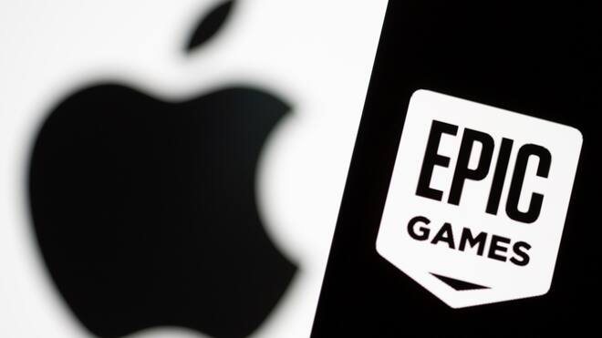 Smartphone with Epic Games logo is seen in front of Apple logo in this illustration