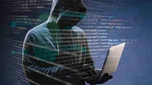 Cyberattacker holding a laptop with black background